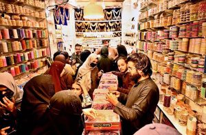 People busy purchasing ‘Peshawari Chappal’ from a vendor while preparing for the upcoming Eid-ul-Fitr at Bacha Khan Chowk.