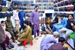 People are busy selecting and purchasing shoes from a shop in a local market on Naya Pul Road in connection with the upcoming Eidul Fitr.