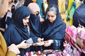 Girls are busy selecting and purchasing cosmetics items from vendor stall at local market in connection with upcoming Eidul Fitr.