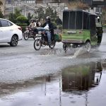 Vehicles on the way during light shower in Twin Cities