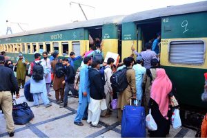 People boarding on train at Railway Station to leave for their hometowns to celebrate Eid-ul-Fitr with their loved ones