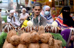 Even the smallest care keeps things alive. A vendor sprays water on coconuts to keep it fresh at Sadar road.