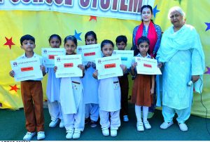 Principle of Royal school system Nighat sarfarz giving among certificates to pass students during result day.