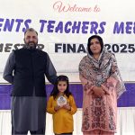 A student who secured first position in the annual examination receives a shield from the school principal during a prize distribution ceremony at Islamabad Career School Ghouri town in the Federal Capital