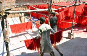 Workers hang vermicelli (seviyan) on bamboo stands for drying after preparation, as demand surges ahead of Eid-ul-Fitr at a local factory in Paretabad during the holy month of Ramazan.