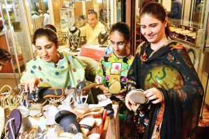 Girls are busy selecting and purchasing cosmetics items from vendor stall at local market in connection with upcoming Eidul Fitr.