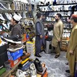 People busy in selecting and purchasing shoes from a shop in connection with upcoming Eidul Fitr