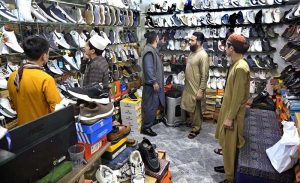 People busy in selecting and purchasing shoes from a shop in connection with upcoming Eidul Fitr