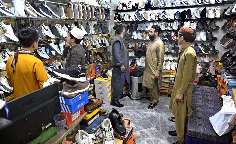 People busy in selecting and purchasing shoes from a shop in connection with upcoming Eidul Fitr