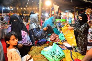 Women busy purchasing ladies’ suits from a vendor stall at the Ramazan Bachat Bazaar while preparing for the upcoming Eid-ul-Fitr during the holy month of Ramazan at Unit No.8 Latifabad .
