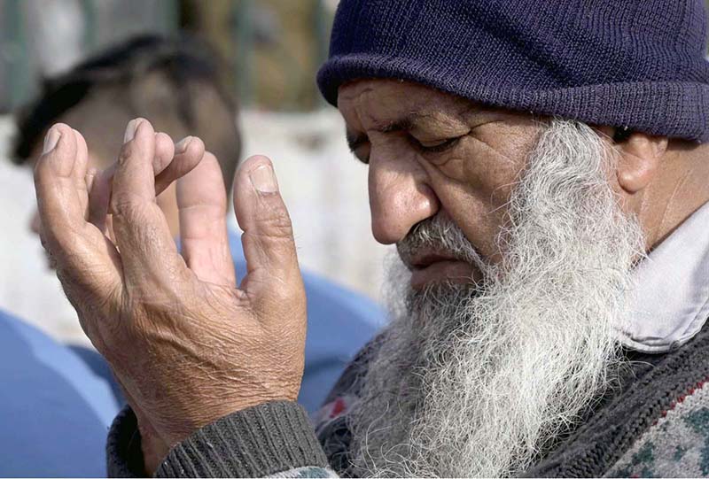 An elderly faithful offering dua after the Eidul Fitr prayer at Eidgah Sharif