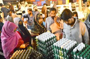 Women busy purchasing ladies’ suits from a vendor stall at the Ramazan Bachat Bazaar while preparing for the upcoming Eid-ul-Fitr during the holy month of Ramazan at Unit No.8 Latifabad .
