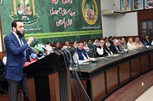 Federal Minister for Information and Broadcasting Attaullah Tarar stands during the national anthem at a ceremony marking the fourth death anniversary of former President Muhammad Rafique Tarar at Nazariya Pakistan Trust