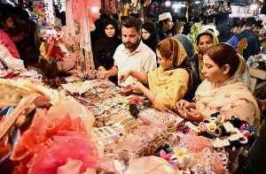A large number of people busy shopping for preparation of upcoming Eid-ul-Fitr at Resham Bazaar.