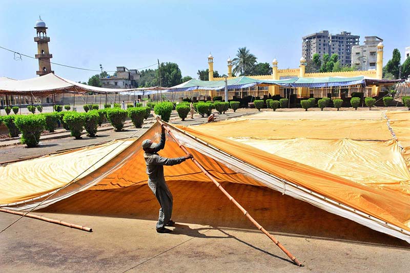 Labourers busy installing tent for Eidul Fitr prayer at Eid Gah Masjid