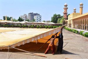 Labourers busy installing tent for Eidul Fitr prayer at Eid Gah Masjid