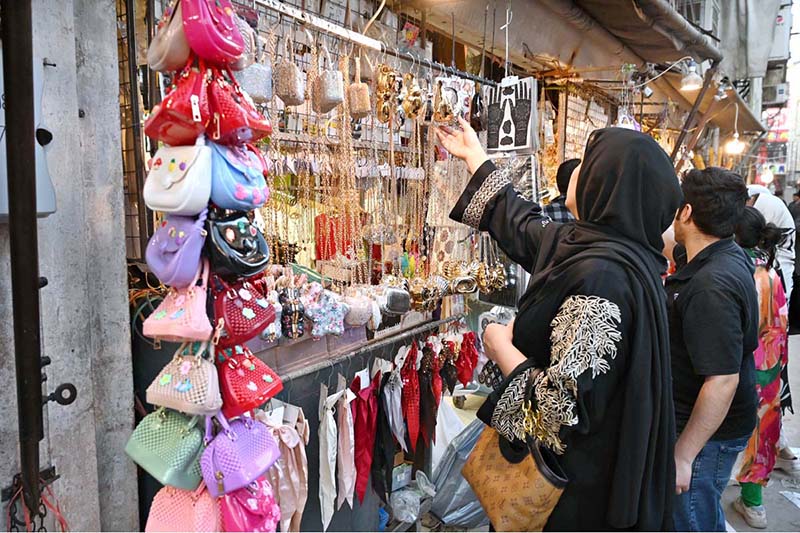 Women are busy selecting and purchasing artificial jewelry for preparation of Eidul Fitr at G-9 Market