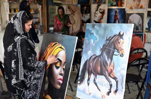 - A young female artist meticulously works on a landscape painting, showcasing her talent in public spaces. At H-9 Bazaar in the federal capital, creativity and artistry come alive for the community to enjoy.