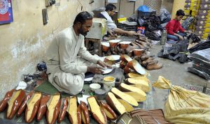 A worker preparing shoes at his work place near fort area in connection with upcoming Eidul Fitr.