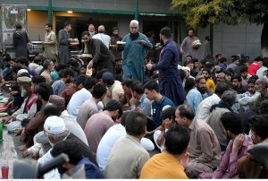 Volunteers serving free food to the people breaking fast during Iftar in the holy month of Ramazan ul Mubarak at I-9 sector.