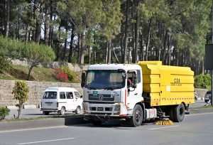 CDA worker is busy cleaning the Islamabad Expressway using a specialized vehicle in the Federal Capital.