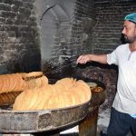 A vendor prepares traditional pheni (fried vermicelli) at his shop as demand increases ahead of Eidul Fitr