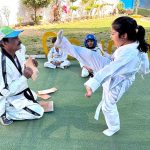 A young Taekwondo student practices a powerful kick to break tiles during a training session at a city school in Qasimabad.