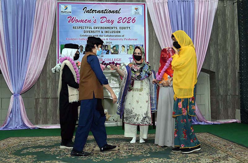 Female students presenting tableau on stage during International Women's Day organized by Hum Log at Govt. Frontier College for Women