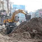 Workers are busy digging to lay a sewage pipeline with the help of machinery in the Hussain Agahi area
