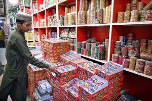 A young vendor displaying colorful bangles to attract the customers at G-9 Market in connection with Eidul Fitr