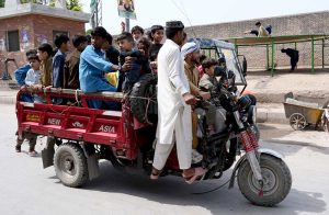 A large number of children enjoy tri-wheeler ride at Tehsil area during Eid holidays.