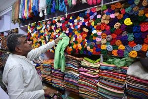 A man is busy purchasing shoes for the upcoming Eid-ul Fitr at Resham Gali