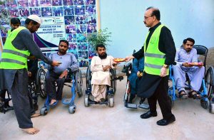 Volunteers distribute Iftari to differently-abled persons at the Association for the Welfare of Handicap Persons during an Iftar Dastarkhwan organized by SDYC in the holy month of Ramazan.