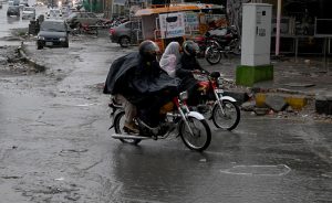 Vehicles passing through the stagnant water at IJP Road during rain in the Federal Capital.