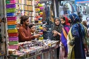 A young vendor displaying colorful bangles to attract the customers at G-9 Market in connection with Eidul Fitr