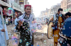 Every bubble is a new hope of life. A street vendor displaying and selling bubble guns to attract kids at Clock Tower Chowk.