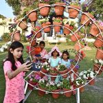 A girl taking selfie with call phone during 22nd Annual Garden Competition & Spring Flower Show 2026 organized by Cantonment Board Hyderabad at Lt. Col. Hassan (Shaheed) Family Park, Qasim Chowk