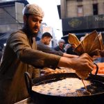 A vendor busy in preparing traditional sweet item jalebi for the customers at Fawara Chowk