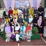 Chairman Hum Log Augustin Jacob poses in a group photo with officials and participants during International Women’s Day at Government Frontier College for Women