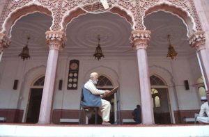 A person reciting the Holy Quran after prayer during the Holy fasting month of Ramazan at Sunehri Masjid.