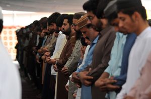 A security official stands on high alert as a large number of faithful offer the fourth Namaz-e-Juma (Friday prayer) during the holy month of Ramazan at Eidgah Masjid amid strict security arrangements.
