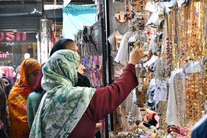 A young vendor displaying colorful bangles to attract the customers at G-9 Market in connection with Eidul Fitr