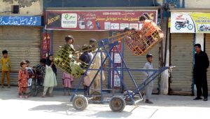 Happiness has not limits. Children enjoy mechanical swing at a roadside vendor’s setup.