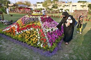 A girl taking selfie with call phone during 22nd Annual Garden Competition & Spring Flower Show 2026 organized by Cantonment Board Hyderabad at Lt. Col. Hassan (Shaheed) Family Park, Qasim Chowk