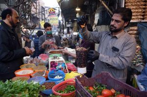 A vendor busy in preparing traditional sweet item jalebi for the customers at Fawara Chowk