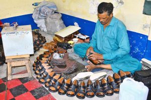 A cobbler prepares popular leather sandals in bulk at his workshop to meet the growing demand ahead of Eid-ul-Fitr.