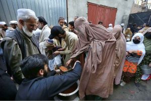Volunteers are distributing free food to poor and deserving people on Warsak Road before iftar during the holy fasting month of Ramazan.
