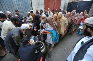 Volunteers are distributing free food to poor and deserving people on Warsak Road before iftar during the holy fasting month of Ramazan.