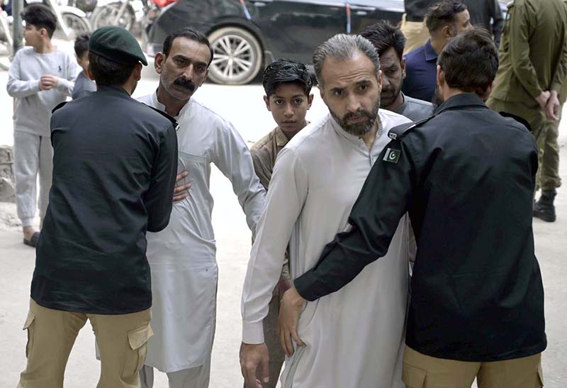 Security officials checking faithful arriving for offering Juma-tul-Wida (last Friday prayer) during the holy month of Ramazan at Markazi Jamia Masjid