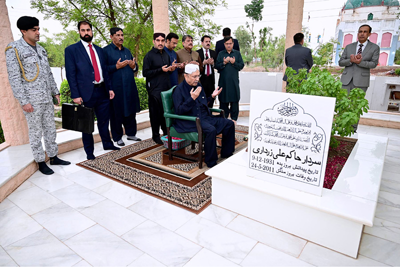 President Asif Ali Zardari offers Fateha after laying a wreath on the grave of his father, Hakim Ali Zardari, at Baloo Ja Quba